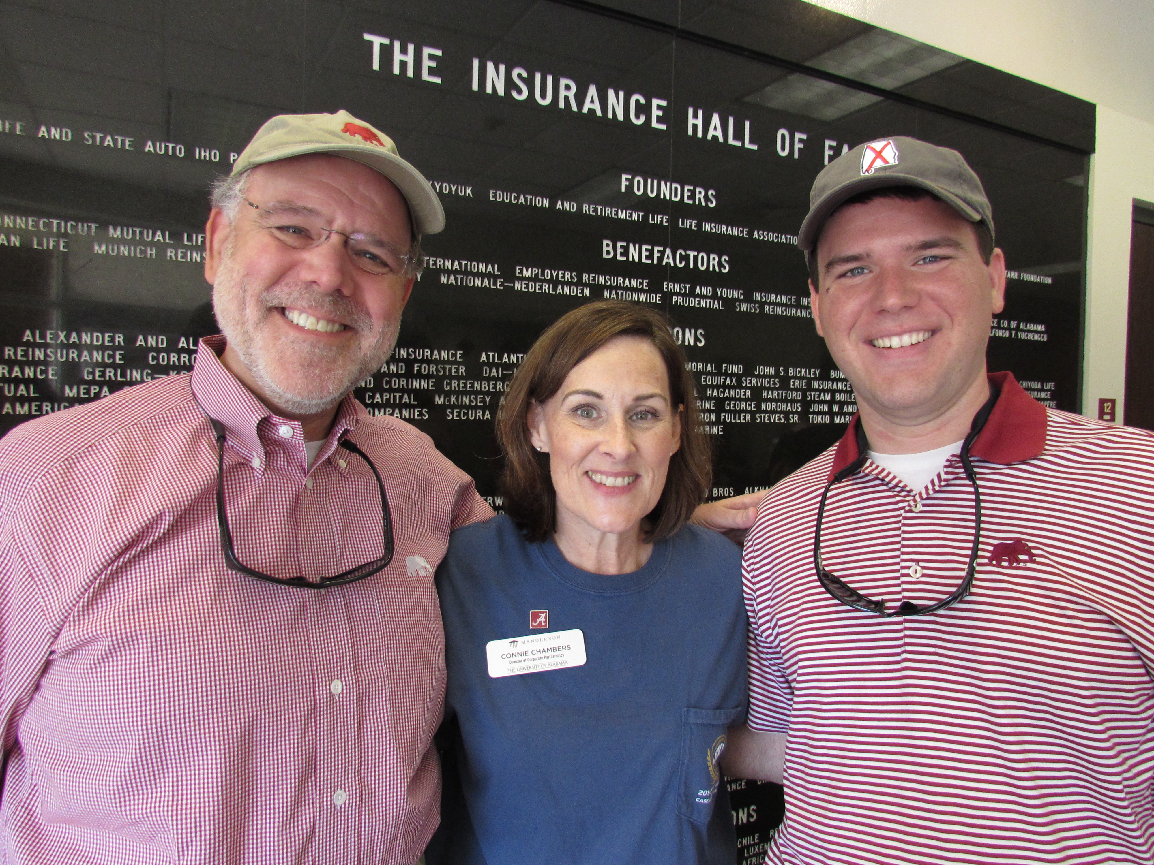Tim Smalley (EMBA 2009) and son Drew (MBA 2015) pose with Connie Chambers